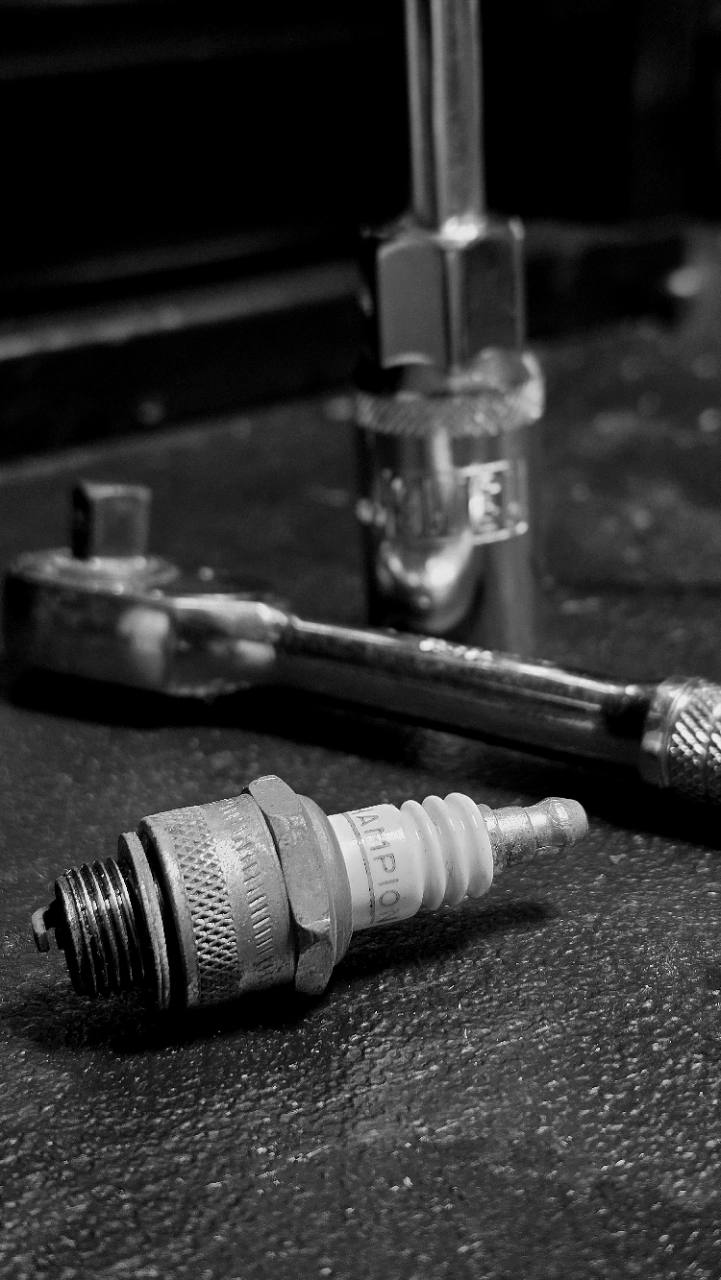 Spark plug and hand tools used during small-engine service